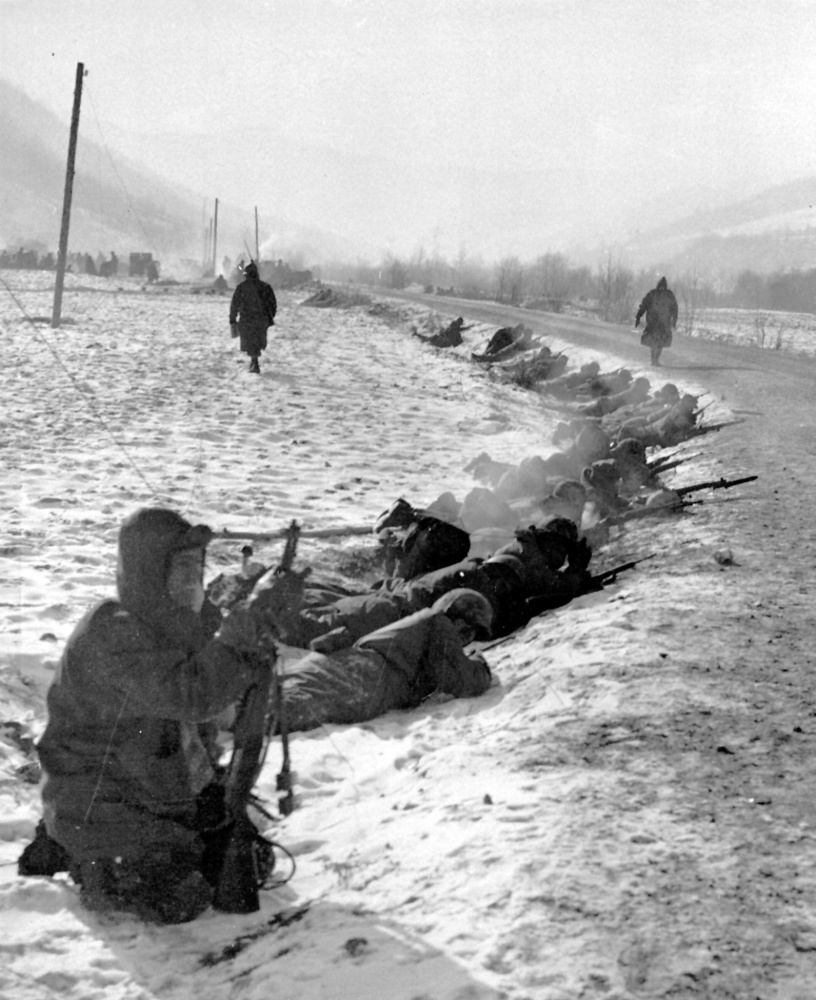 Marines lie in the snow with rifles ready at a curve in a road in the Chosin Reservoir area on Nov. 29, 1950.
Associated Press via U.S. Marine Corps