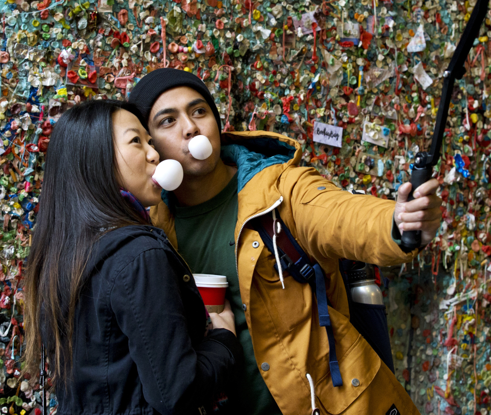 Jessica Wang, left, and Michael Teylan, both of Los Angeles, visit the gum wall Monday, a day before its cleaning began.