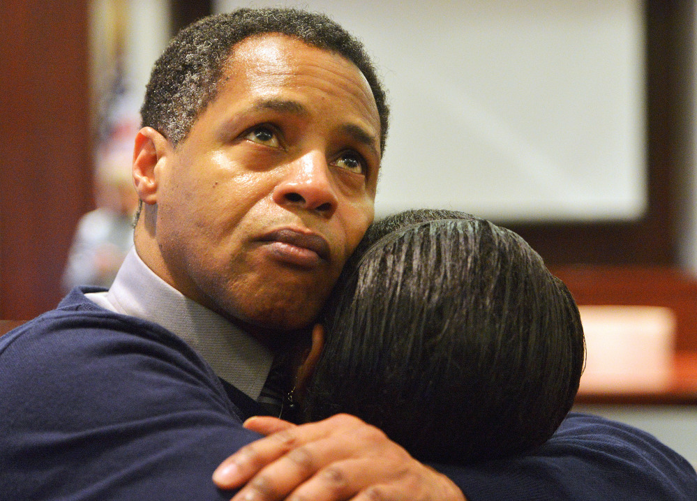Timothy Johnson embraces a family member in 2013 after he was found not guilty of a 1984 killing. Monday he filed a federal civil rights suit.