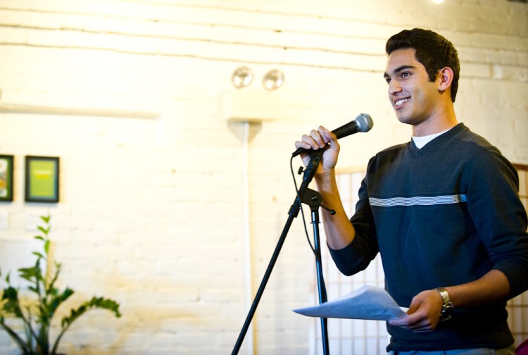 Ibrahim Shkara reads a story to a crowd of over 80 community members, including mentors, at the Telling Room in Portland in June.
Photo by Winky Lewis