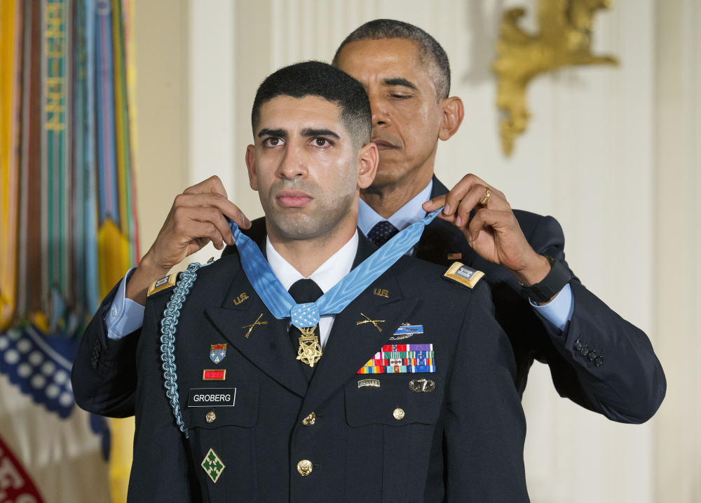 President Barack Obama bestows the nation’s highest military honor, the Medal of Honor, on retired Army Capt. Florent Groberg during a ceremony in the East Room of the White House in Washington on Thursday.