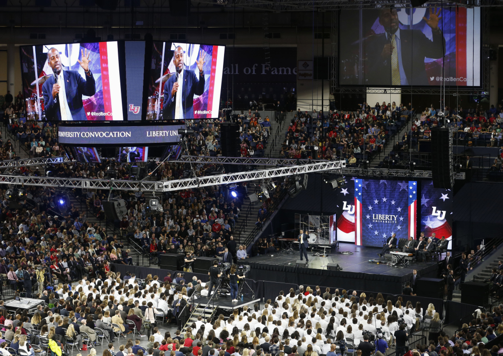 Republican Presidential candidate Dr. Ben Carson speaks at Liberty University in Lynchburg, Va., on Wednesday. Carson adheres to a tough-on-crime message, yet has maintained his business relationship with a dentist who pleaded guilty to insurance fraud.