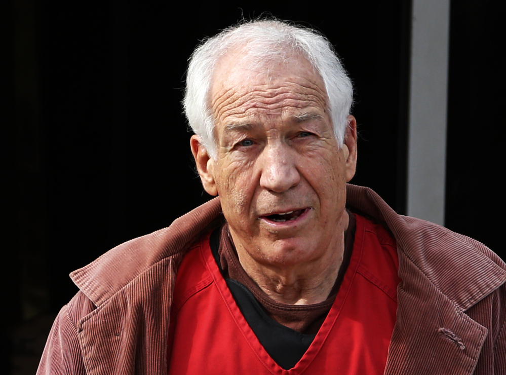 Former Penn State assistant coach Jerry Sandusky leaves court on Oct. 29.