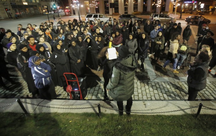 Hamdi Hassan, center, a sophomore at the University of Southern Maine, speaks during a rally held in Monument Square on Friday night to show support for students at the University of Missouri who are protesting racial incidents at their school. About 150 people from USM, Bowdoin College and Portland high schools attended the rally.