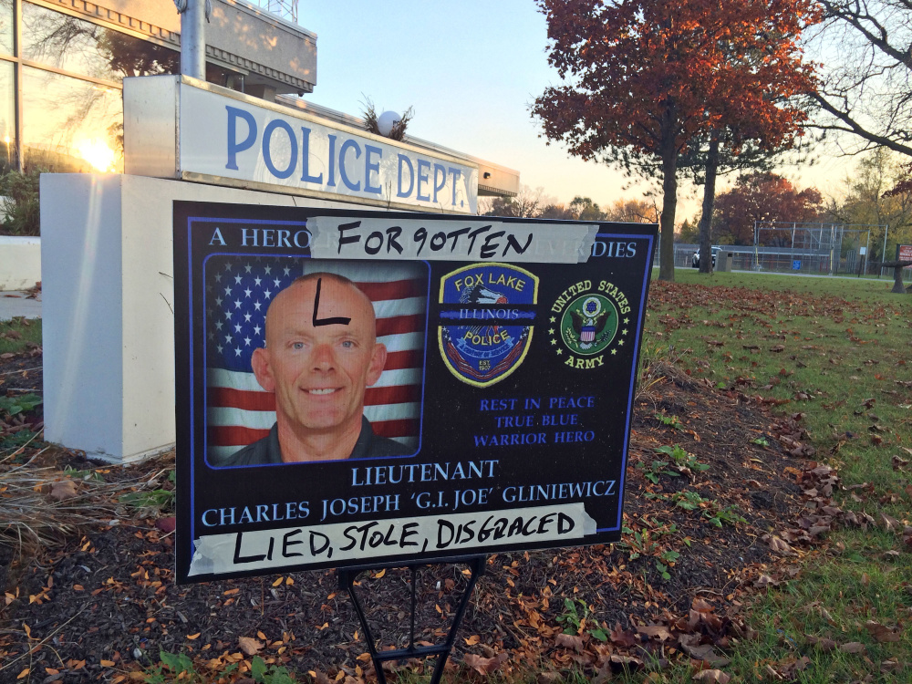A sign honoring Fox Lake Police Lt. Charles Joseph Gliniewicz is defaced outside Fox Lake Police Department in Fox Lake, Ill. Lake County officials confirmed Wednesday that Gliniewicz, 52, died Sept. 1 of a self-inflicted gunshot wound. Officials said Gliniewicz carefully staged his death to make it look like he was killed in the line of duty and had been stealing for years from a youth program he oversaw.