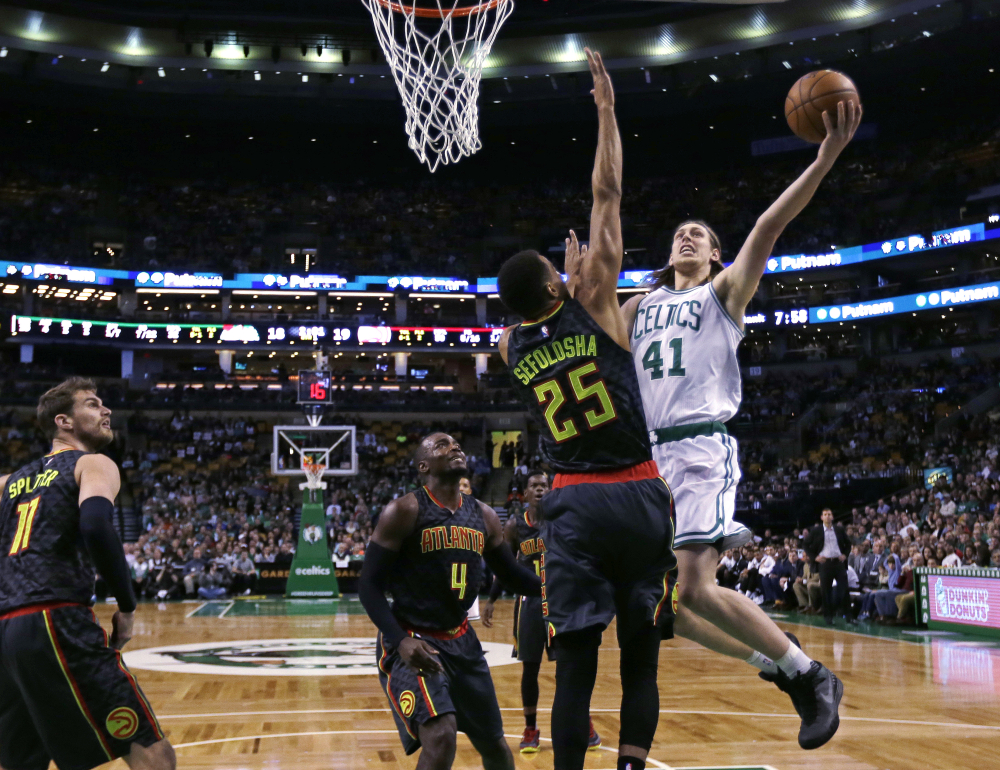 Celtics center Kelly Olynyk drives to the basket as Hawks guard Thabo Sefolosha defends during the first quarter.