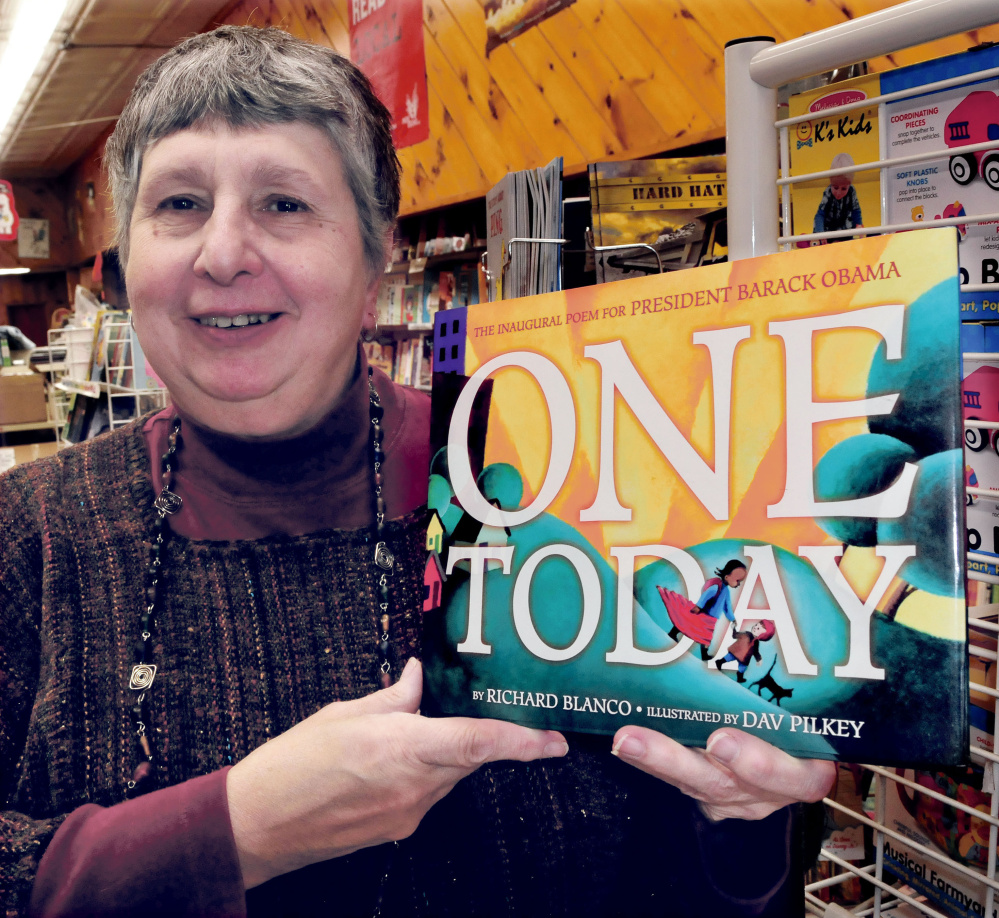 Ellen Richmond, who owns the Children’s Book Cellar in Waterville, holds a copy of a new children’s book by Richard Blanco. She is hosting a reading by the Bethel poet at the Waterville Opera House on Dec. 15. He will sign copies of his books after the event.