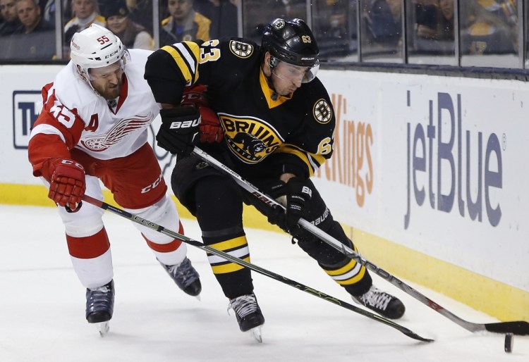 Detroit’s Niklas Kronwall, left, defends against Brad Marchand during Boston’s 3-1 win Saturday night at the TD Garden. It was just the second home win of the season for the Bruins in eighth games.