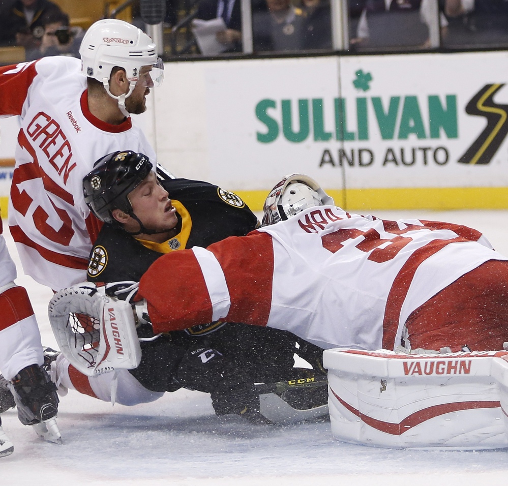 Matt Beleskey of the Bruins collides with Red Wings goalie Petr Mrazek, right, and defensive Mike Green after a goal by Patrice Bergeron in the second period.