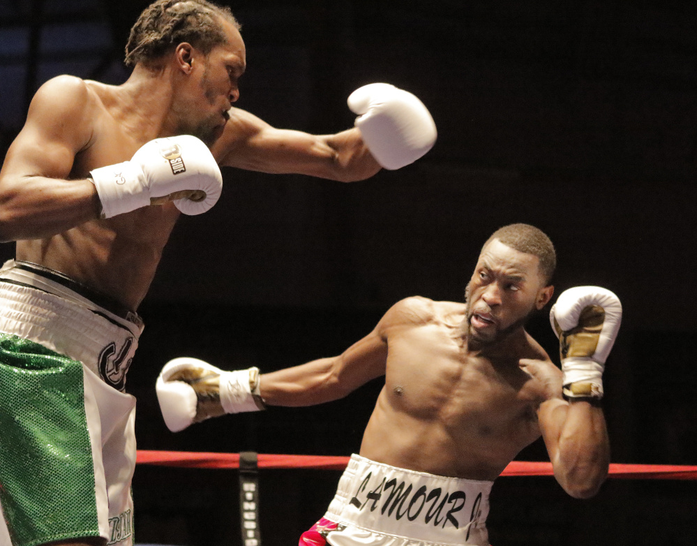 Russell Lamour Jr. ducks a punch thrown by Thomas Falowo and throws a punch of his own. Falowo handed Lamour the second loss of his professional career. Gregory Rec/Staff Photographer