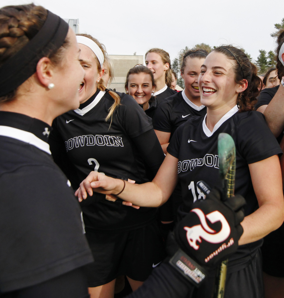 Rachel Kennedy, right, became the first Polar Bear to score 100 career goals, then celebrated with teammates after Bowdoin advanced to the final four for the ninth time in 11 years.