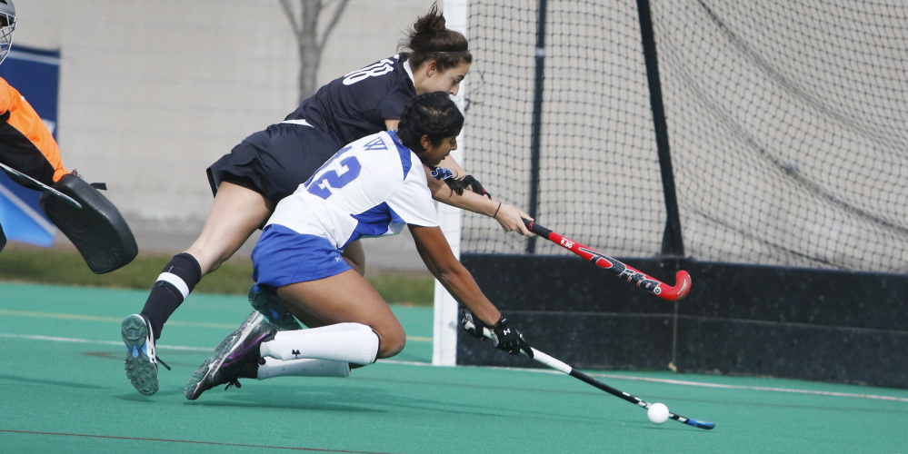 Bowdoin’s Rachel Kennedy, left, battles for possession with Neha Vellanki of Wellesley during a third-round match in the NCAA Division III field hockey tournament Sunday in Brunswick. Kennedy scored twice in a 3-0 win.