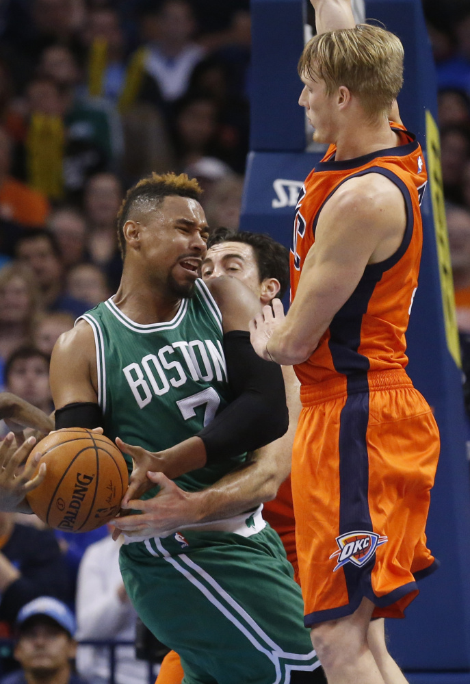 Boston’s Jared Sullinger is fouled by Nick Collison, center, while being defended by Kyle Singler during the Celtics’ 100-85 win Sunday in Oklahoma City.