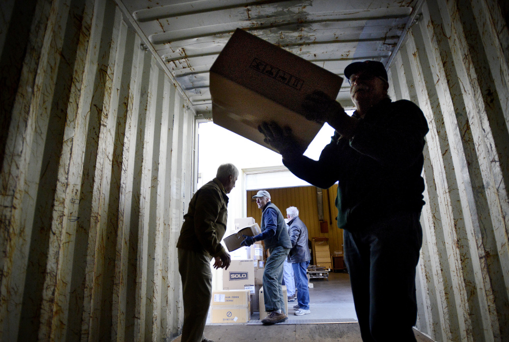 Workers load a truck that will carry 40,000 pounds of medical supplies to Boston for shipping to Turkey on Monday.