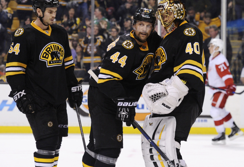 Boston Bruins defenseman Dennis Seidenberg, center, who came back from injury to play a full season in 2014-15, is again starting anew – this time after back surgery.