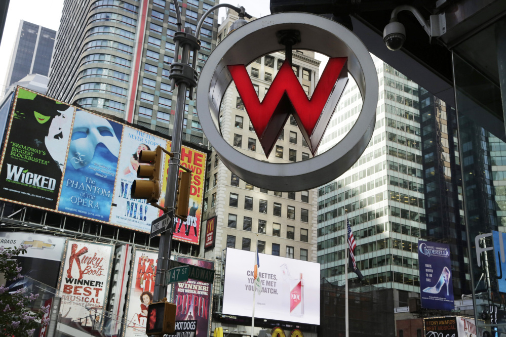 FILE  - In this Wednesday, July 31, 2013, file photo, the logo for the W Hotel, owned by Starwood Hotels & Resorts Worldwide, is seen in New York's Times Square. Marriott International announced Monday, Nov. 16, 2015, it is buying rival hotel chain Starwood for $12.2 billion in a deal that will secure its position as the world's largest hotelier. (AP Photo/Mark Lennihan, File)