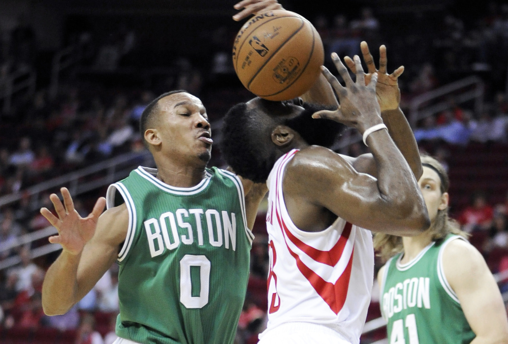 Boston’s Avery Bradley knocks the ball away from the Rockets’ James Harden, who gets it in the face.