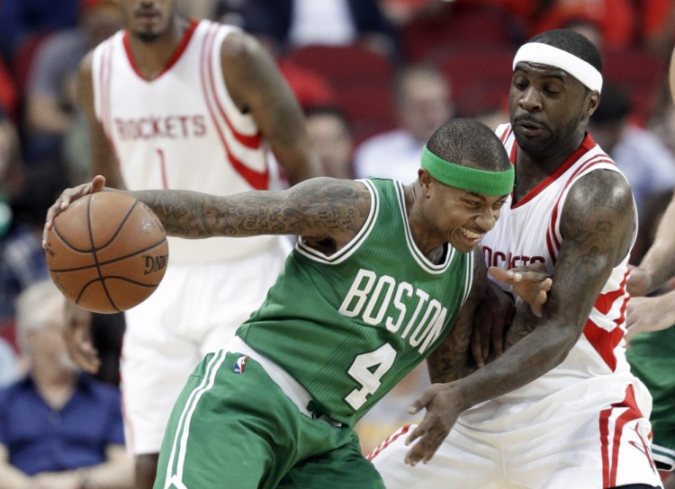 Celtics guard Isaiah Thomas pushes against the Rockets’ Ty Lawson on a possession in the first half of Boston’s win Monday night in Houston. Thomas led the Celtics with 23 points in the game.