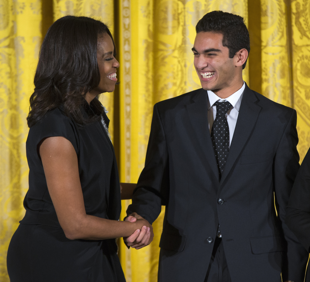 First lady Michelle Obama shakes hands with Ibrahim Shkara of The Telling Room in Portland, Maine, during the 2015 National Arts and Humanities Youth Program Awards on Tuesday at the White House in Washington.