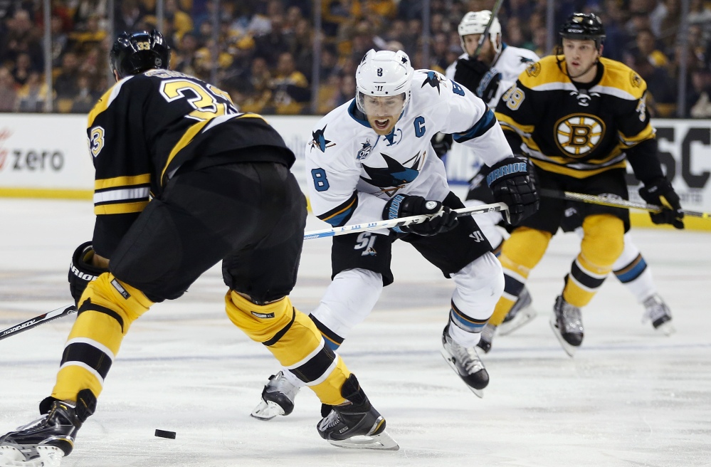 San Jose’s Joe Pavelski brings the puck up ice as the Bruins’ Zdeno Chara defends in the first period of the Sharks’ 5-4 win Tuesday night in Boston.