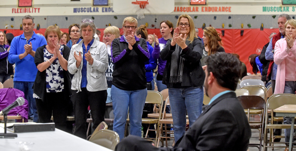 Despite accusations that he sought sex from a high school girl, Don Reiter, seated, still received a standing ovation from faculty, parents and students during an open hearing Nov. 11 that preceded Monday’s vote by the Board of Education to terminate him as principal.