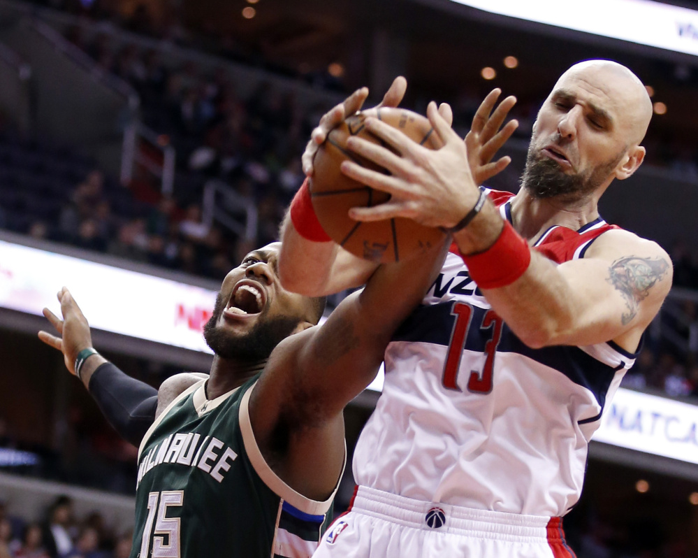 Bucks center Greg Monroe, left, attempts to keep a rebound from the arms of Wizards center Marcin Gortat during Tuesday’s game, a 115-86 Washington home win.