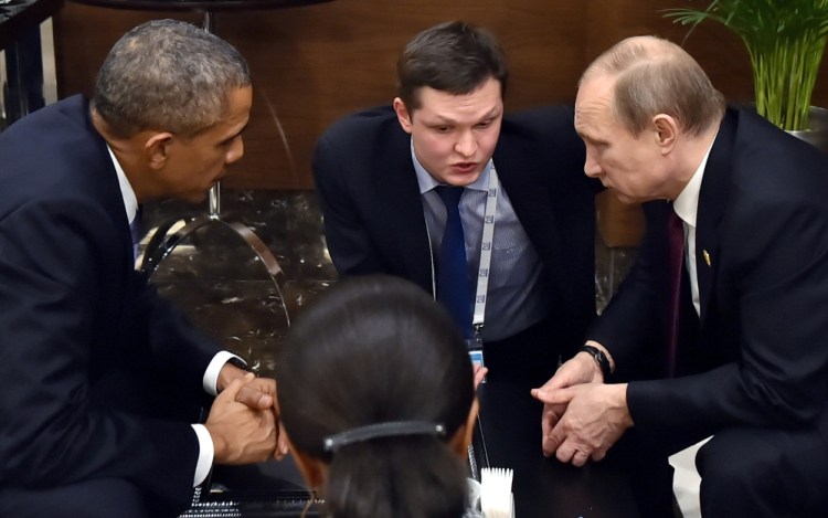 In this Sunday, Nov. 15, 2015, file photo, U.S. President Barack Obama, left, speaks with Russian President Vladimir Putin, right prior to the opening session of the G-20 summit in Antalya, Turkey.