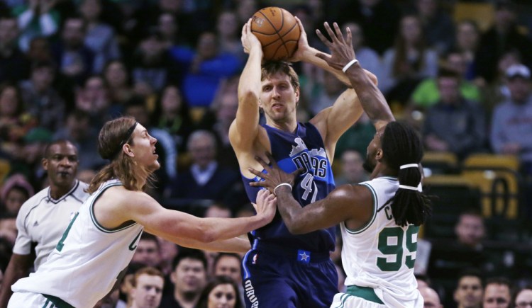 Dallas Mavericks forward Dirk Nowitzki, center, looks to pass while double-teamed by Celtics center Kelly Olynyk and forward Jae Crowder in the first quarter of the Mavericks’ win Wednesday night in Boston. Nowitzki scored 23 points as Dallas won its fifth straight game. The Associated Press
