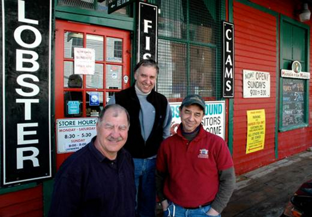 The Alfiero brothers outside Harbor Fish Market, at 9 Custom House Wharf, in Portland,  took over the business from their father in 1990s. From left to right, Nick Alfiero, 65, of Scarborough, Mike Alfiero, 56, of Cape Elizabeth, and Benjamin Alfiero, 59, of Scarborough.