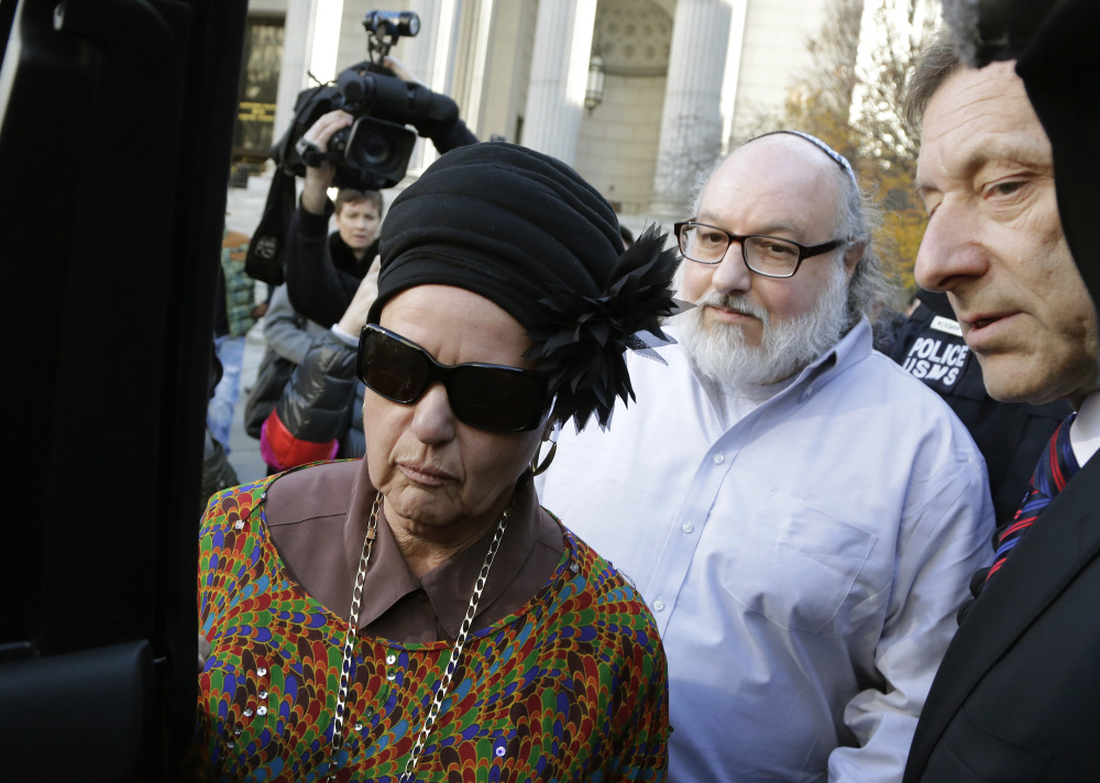 Convicted spy Jonathan Pollard and his wife, Esther, leave the federal courthouse in New York on Friday after Pollard served 30 years for selling intelligence secrets to Israel.