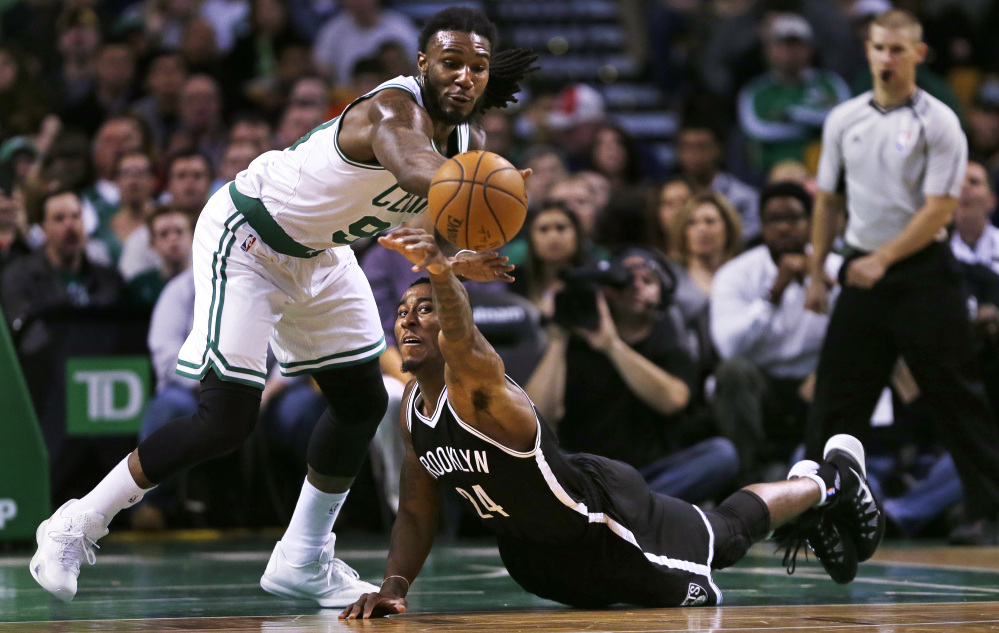 Brooklyn Nets guard Rondae Hollis-Jefferson reaches up as he loses control of the ball next to Celtics forward Jae Crowder in the first quarter of Friday night’s game in Boston. Crowder scored 19 points in the Celtics’ 120-95 win.