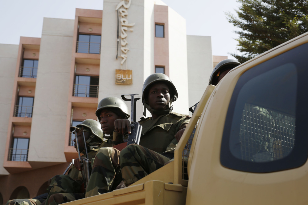 Soldiers from the presidential guard patrol outside the Radisson Blu Hotel in Bamako, Mali, on Saturday in anticipation of the president’s visit.
