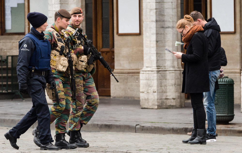 Belgian Army soldiers and a police officer patrol in the Grand Place in the center of Brussels on Friday.