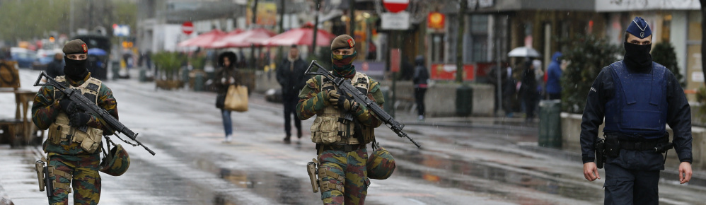 Belgian soldiers and a police officer patrol in central Brussels on Saturday after security was tightened in Belgium following the fatal attacks in Paris.