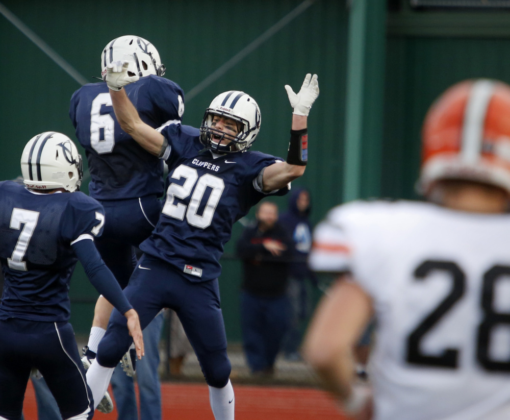 Remi LeBlanc, center, of Yarmouth celebrates with teammates after a 49-yard touchdown reception in the second quarter.  It was the only touchdown for Yarmouth, which had its bid for an undefeated season spoiled by Winslow.