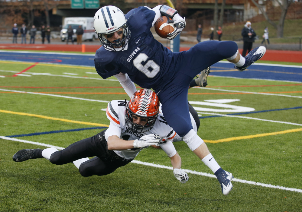 Jack Snyder of Yarmouth tries to avoid Dylan Hutchinson during the second half of Saturday’s Class C state championship game at Fitzpatrick Stadium in Portland. (Derek Davis/Staff Photographer)