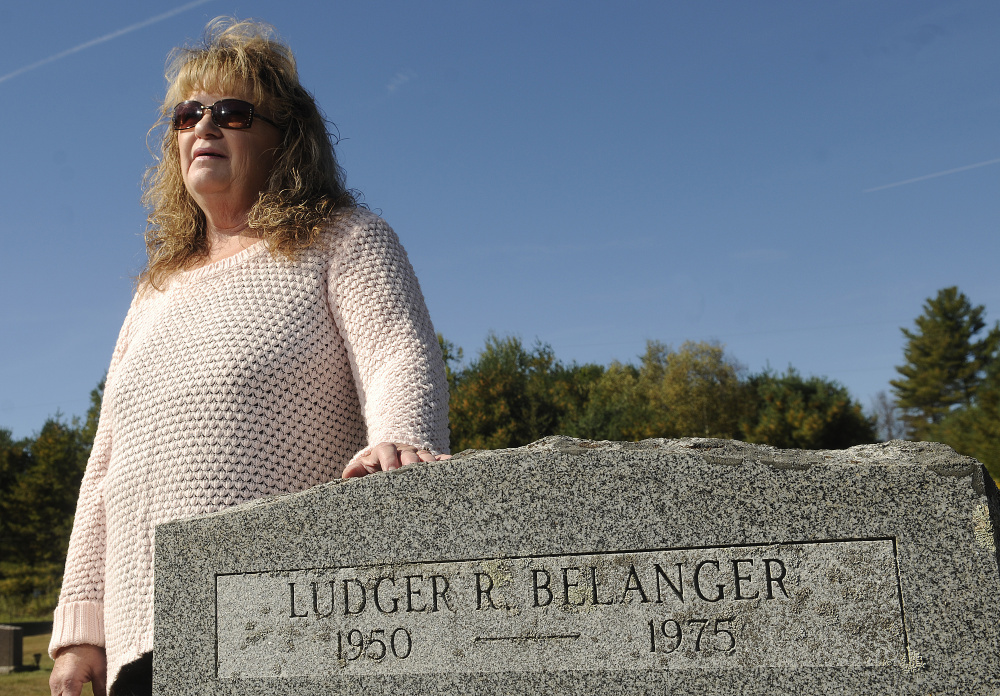 Linda Perkins stands at the gravestone of her first husband, Ludger Belanger, in Somerville in October. Belanger, 25, went hunting 40 years ago and never returned.