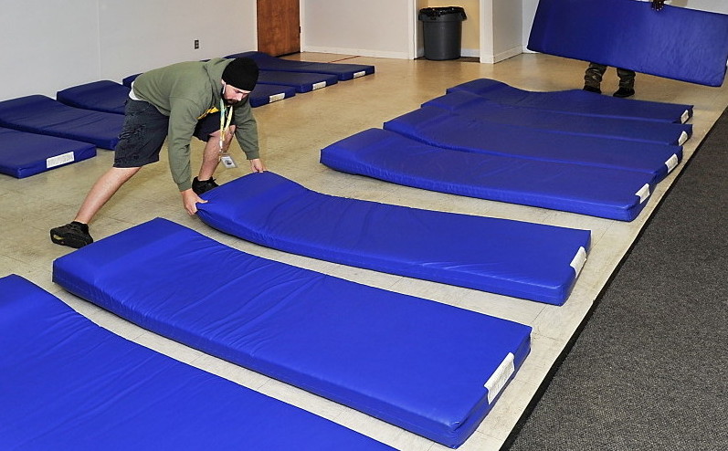 Homelessness may have declined by some measures, but people still rely on mats in the Portland overflow shelters on a nightly basis.
