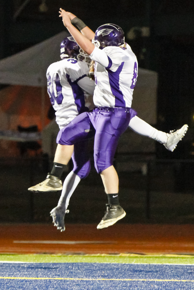 Zach Doyon, left, and Chris Sarzynski of Marshwood celebrate in the end zone after Doyon caught a touchdown pass during the 21-14 victory against Brunswick in the Class B state final at Fitzpatrick Stadium.