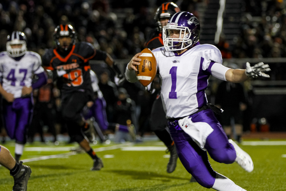 Marshwood quarterback Cole McDaniel looks for an opening during the fourth quarter against Brunswick.