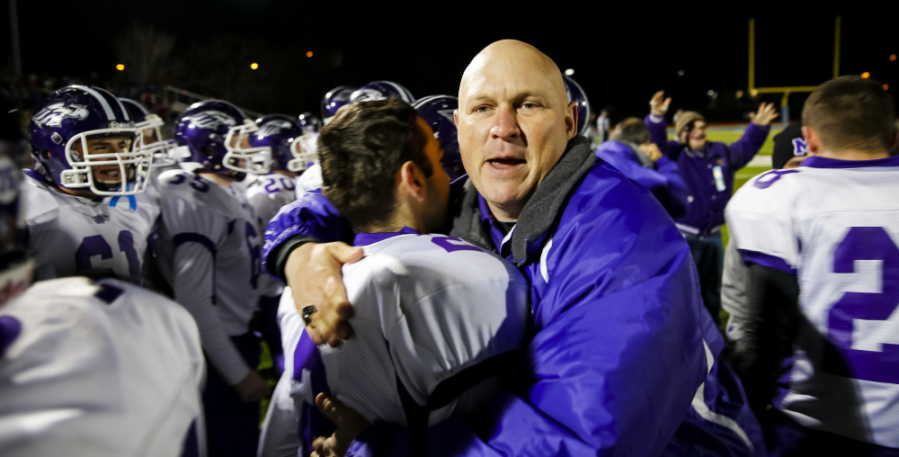 Marshwood assistant coach Larry Kinch celebrates with the team after beating Brunswick in the state championship game again.