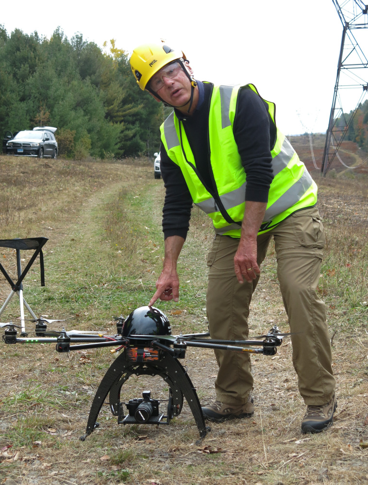 Bernd Lutz, CEO of Boulder, Colorado-based bizUAS Corp., which provides drone services for utilities and other industries, prepares to demonstrate the use of a Cyberhawk octocopter drone for power line inspections at a New York Power Authority site in the Catskills, near Blenheim, N.Y.
