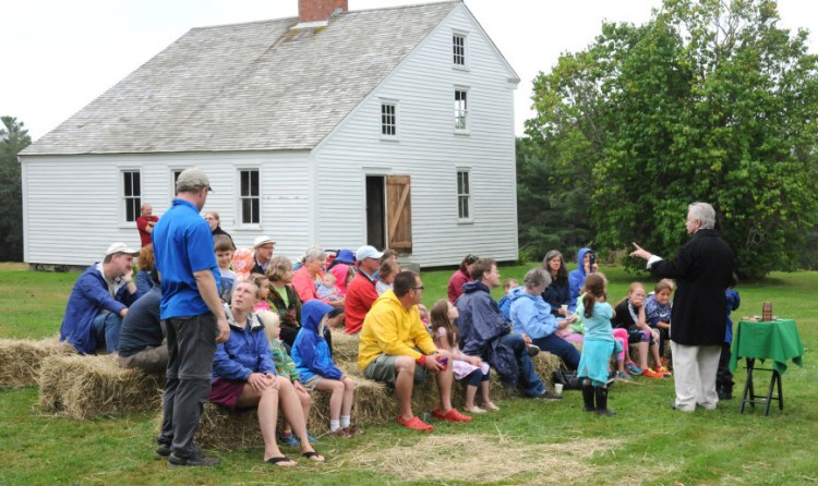 Magician Robert Olsen performs during Pettengill Farm Day. Stewards of the historic farmhouse, known for its etched murals, are dealing with an infestation of powderpost beetles.