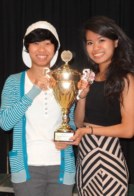 Sanford High School Key Club members Michelle Ouch, left, and Cherlline Ouch pose with a trophy they won for their prize-winning recruiting poster.
