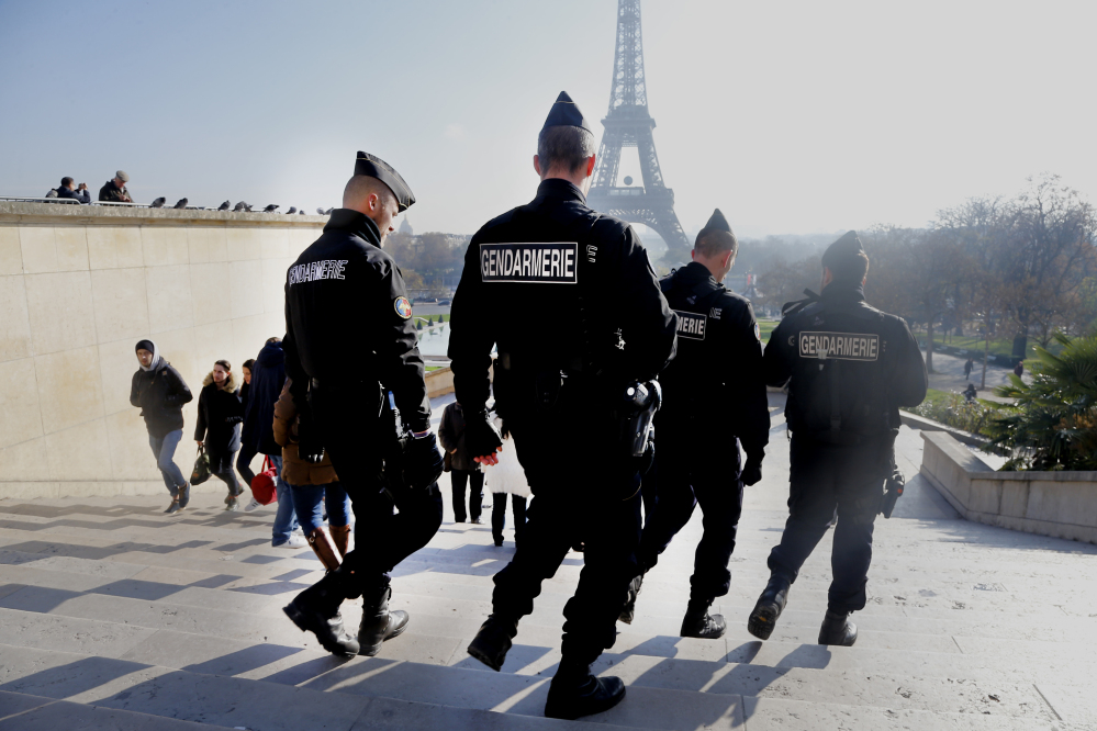 French gendarmes patrol near the Eiffel Tower in Paris on Monday. There are none of the usual long lines to ascend the iconic tower and ticket sales to Paris’ major museums have also plummeted after terrorist attacks in the city.