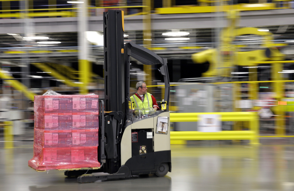 A forklift operator moves goods at an Amazon.com fulfillment center in DuPont, Wash. Amazon can afford to offer delivery services that other retailers can’t.