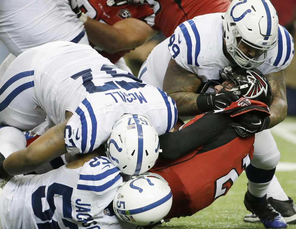 Atlanta quarterback Matt Ryan finds out the hard way that Indianapolis is still a force, as he’s tackled by a trio of defenders – D’Qwell Jackson, bottom, T.Y. McGill, left, and Billy Winn, top right, during the Colts’ 24-21 win Sunday at Atlanta.