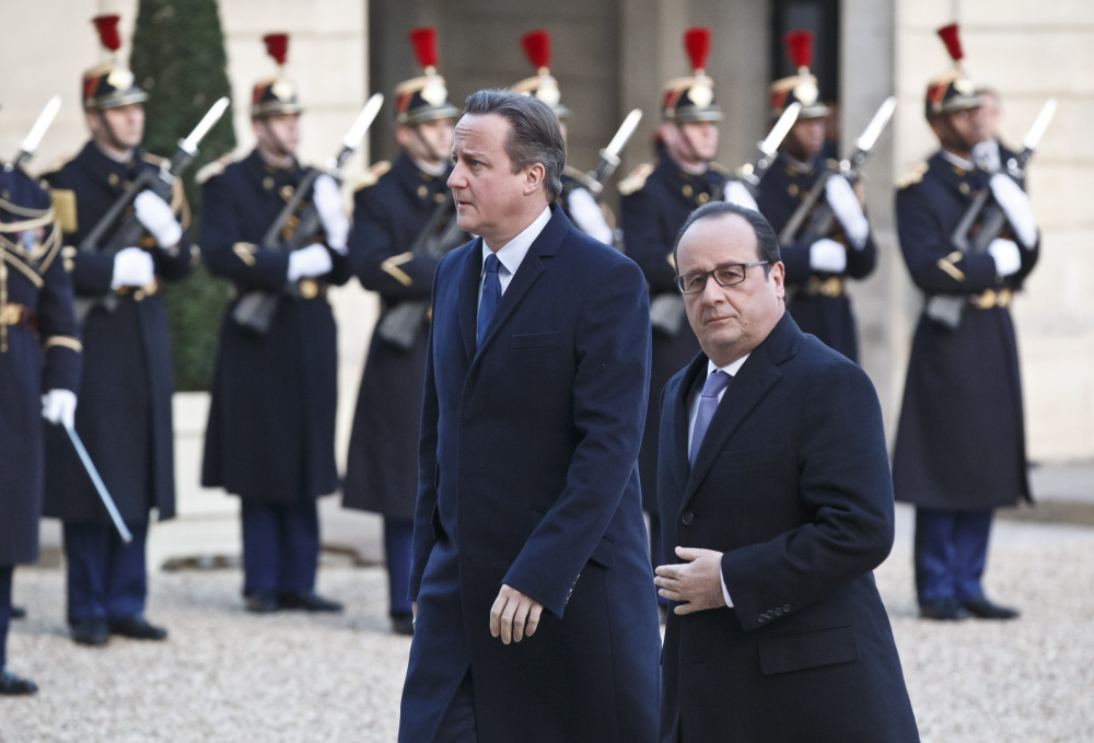 Britain’s Prime Minister David Cameron, left, and France’s President Francois Hollande arrive at the Elysee Palace in Paris, on Monday.