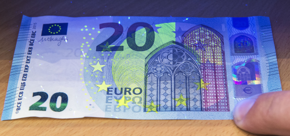 Ultraviolet light shows the security features of the new 20 euro banknote set to be introduced across the 19-country eurozone on Wednesday.