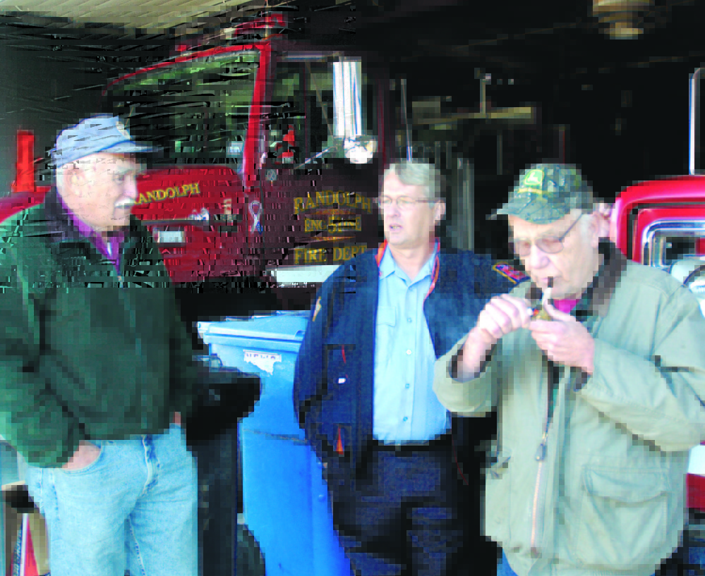 Lewis “Duddy” Brown, left, Ron Cunningham and Andy Cooper chat in 2007 in the bay of the Randolph Fire station. Brown died Monday night after being hit by a car outside his home in Pittston.